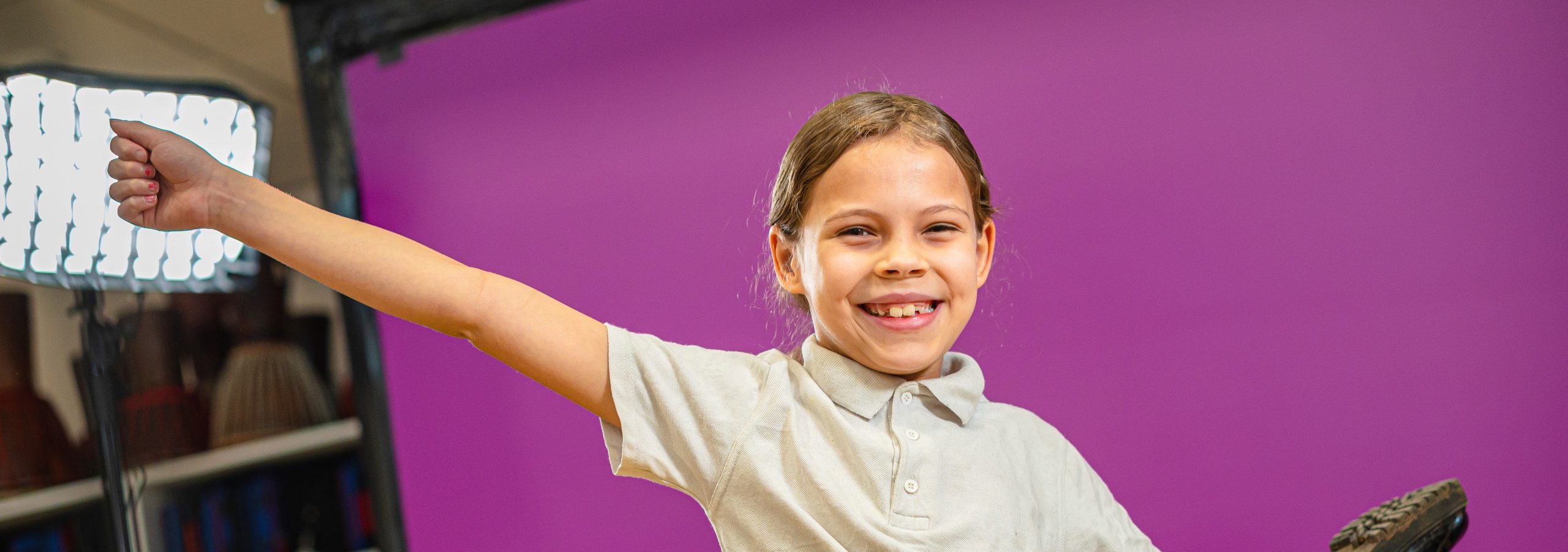 A young primary school girl striking a gymnastics pose