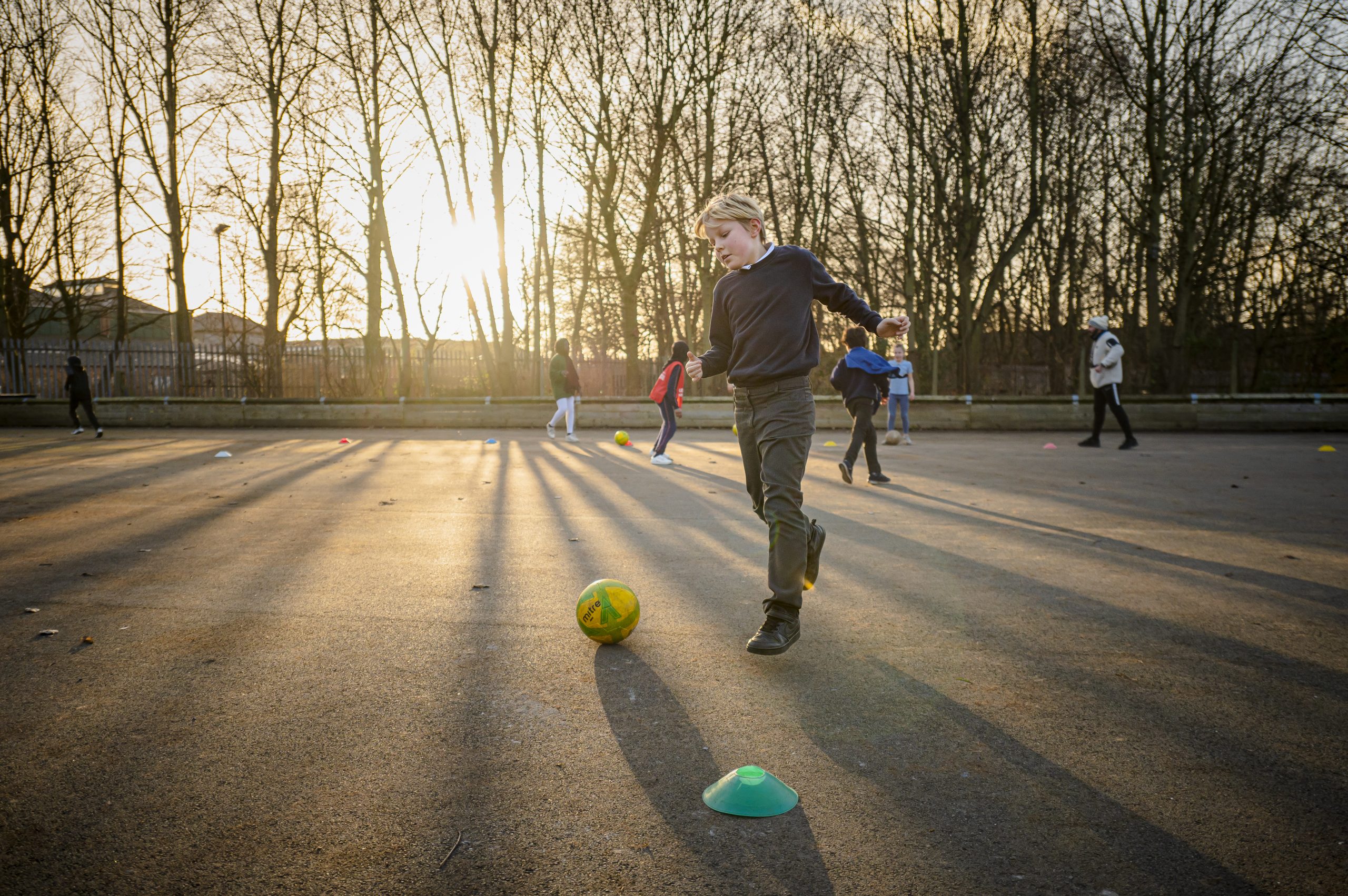 A young boy playing football