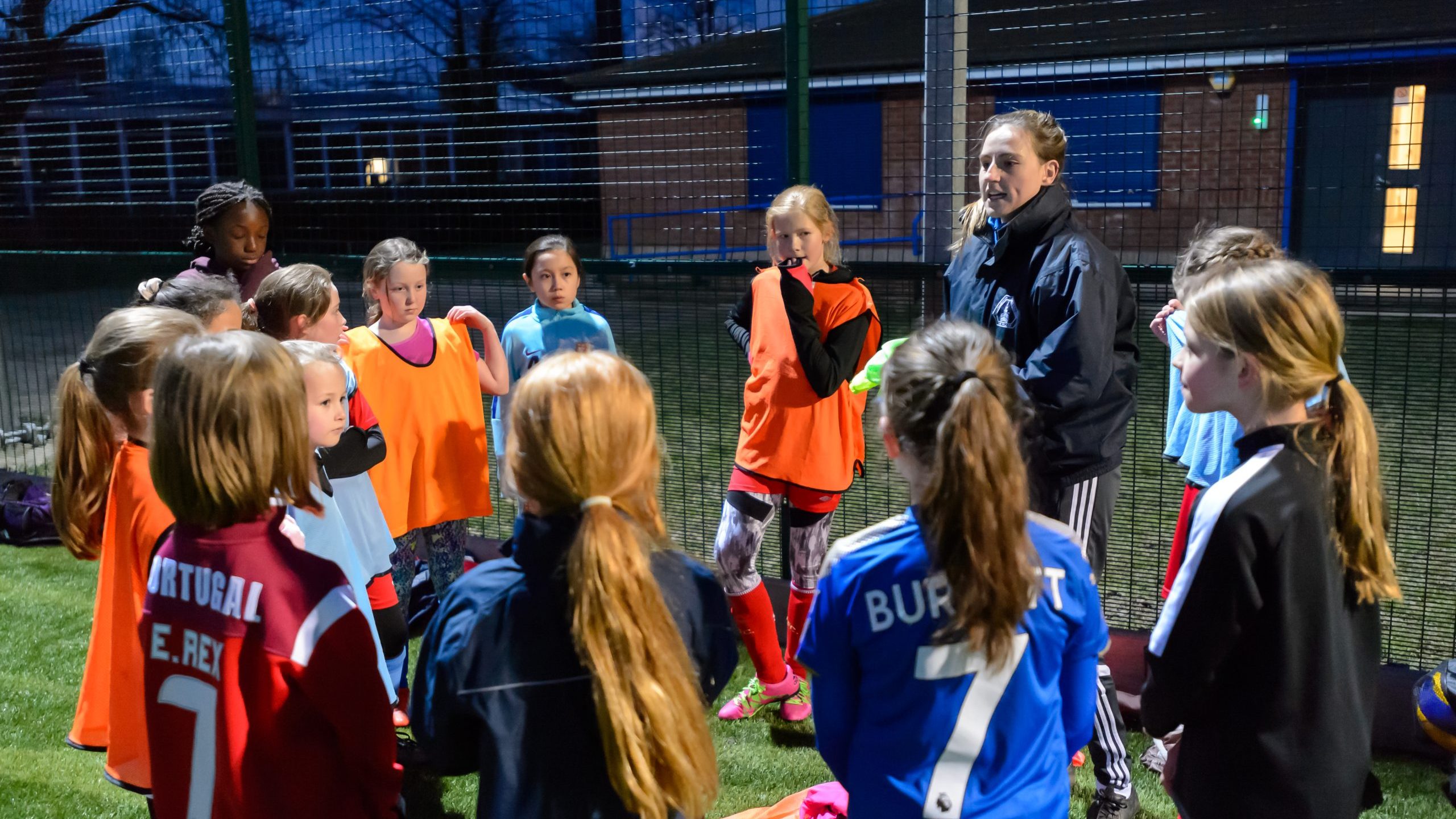 Young girls gathered in a circle after football training