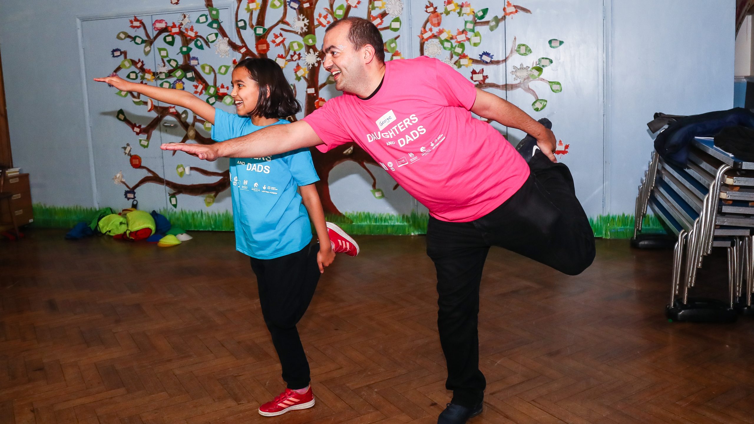 Dad George and his daughter balancing