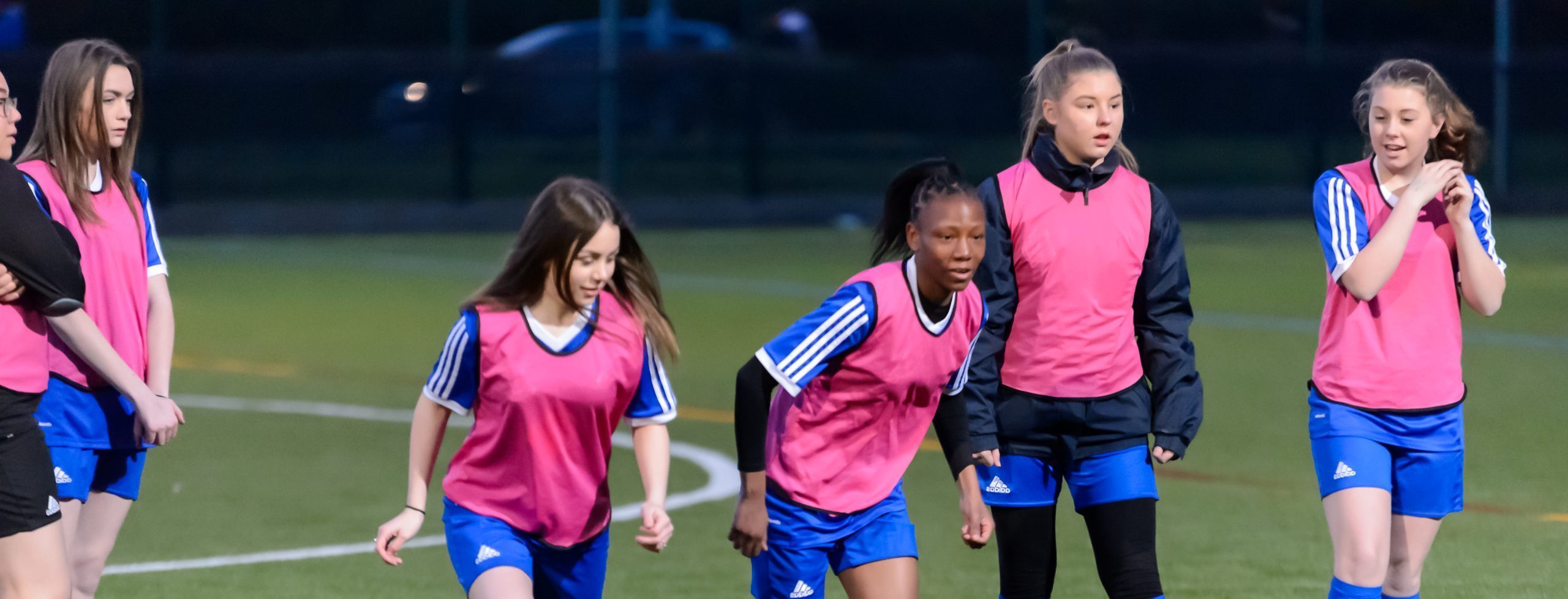 Teenage girls playing football