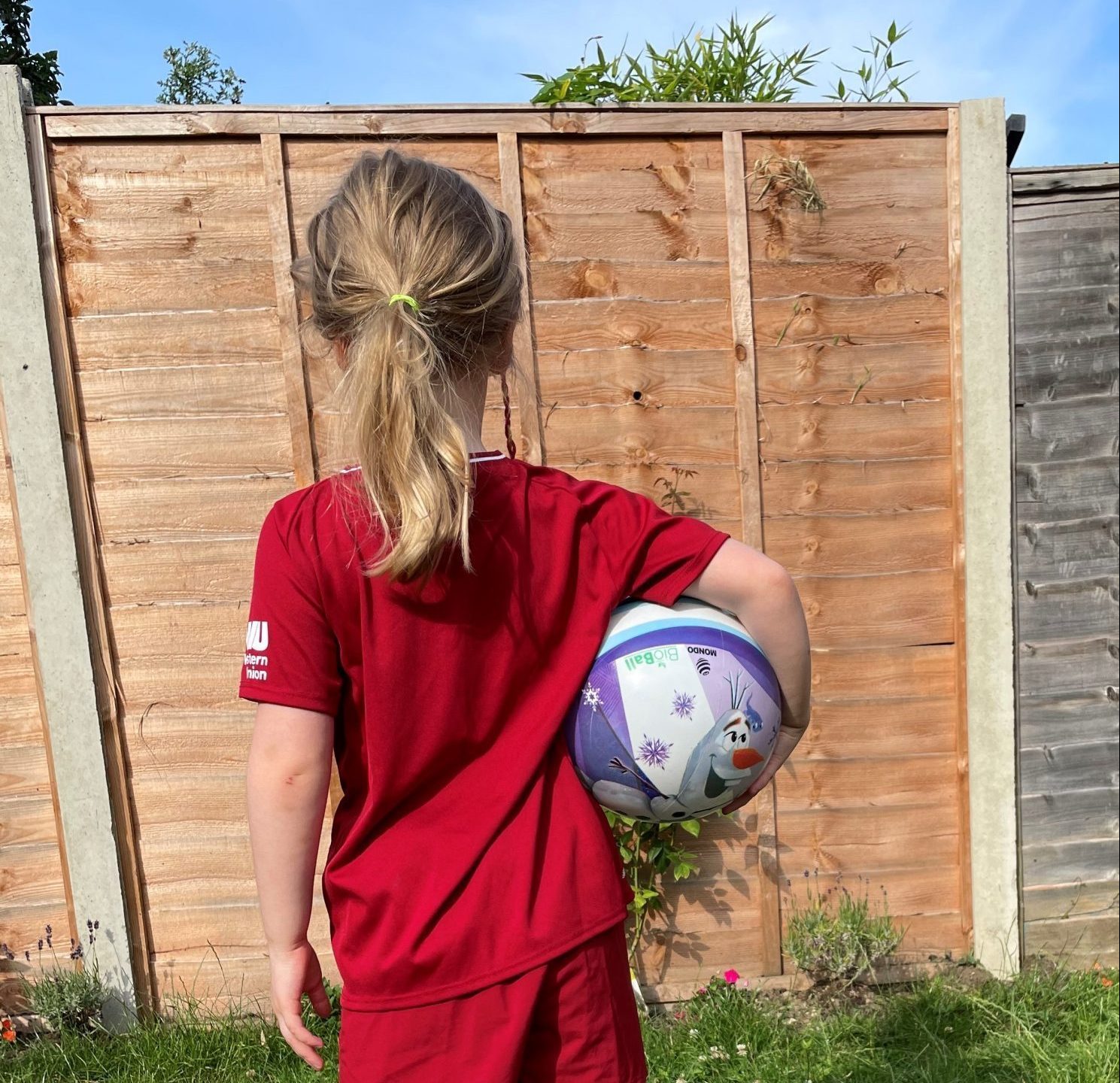 Emily's daughter in her football kit