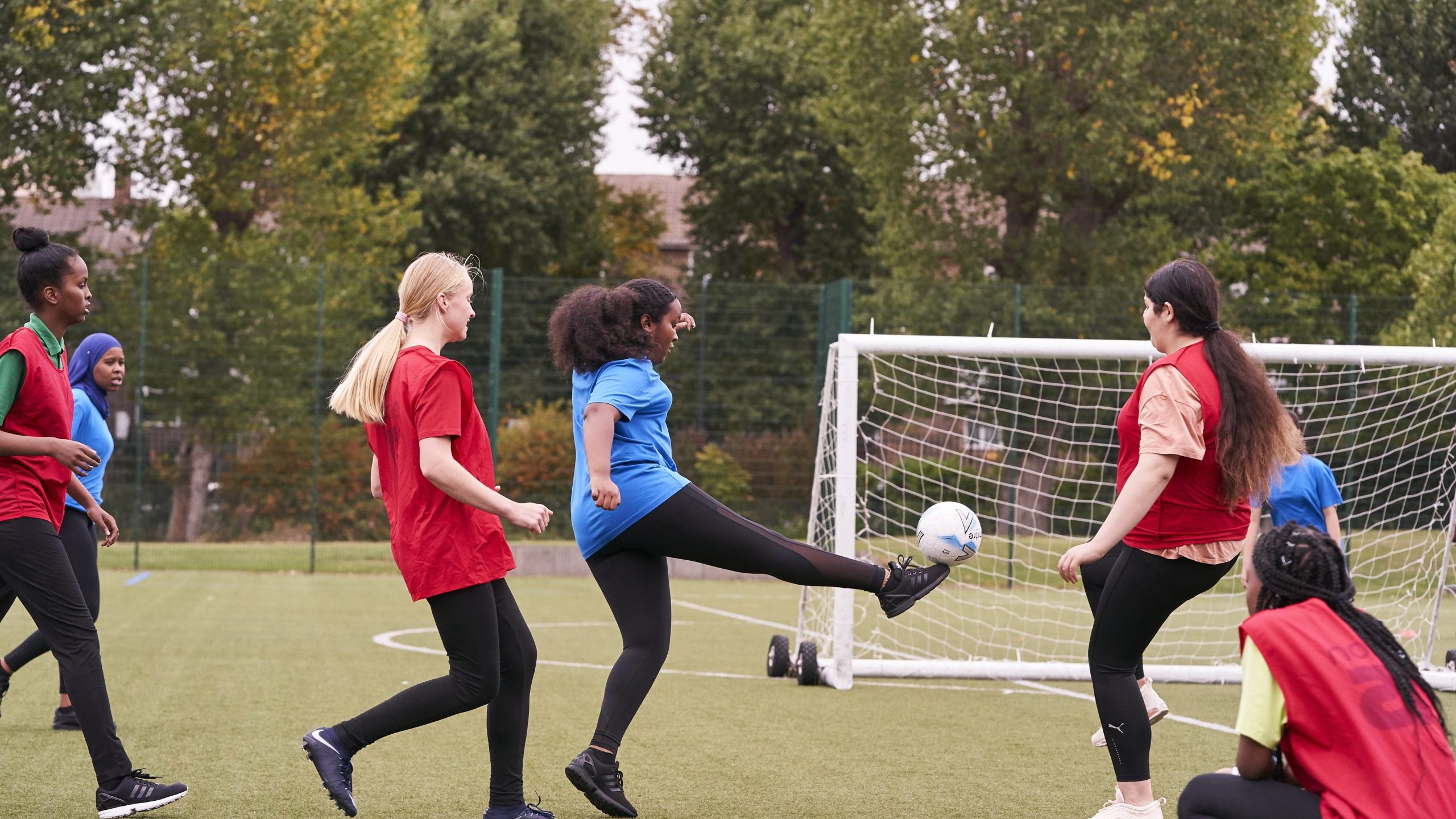 Teenage girls playing football