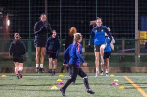 Women's football team playing in the dark