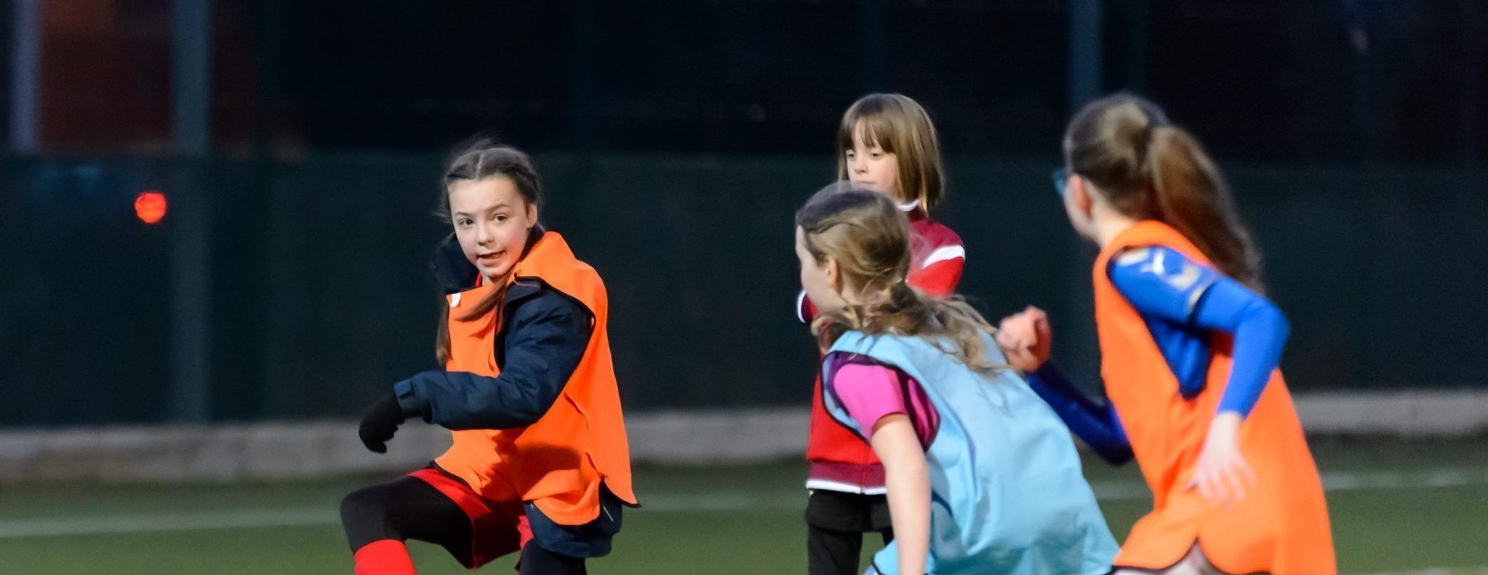 A group of young girls playing football