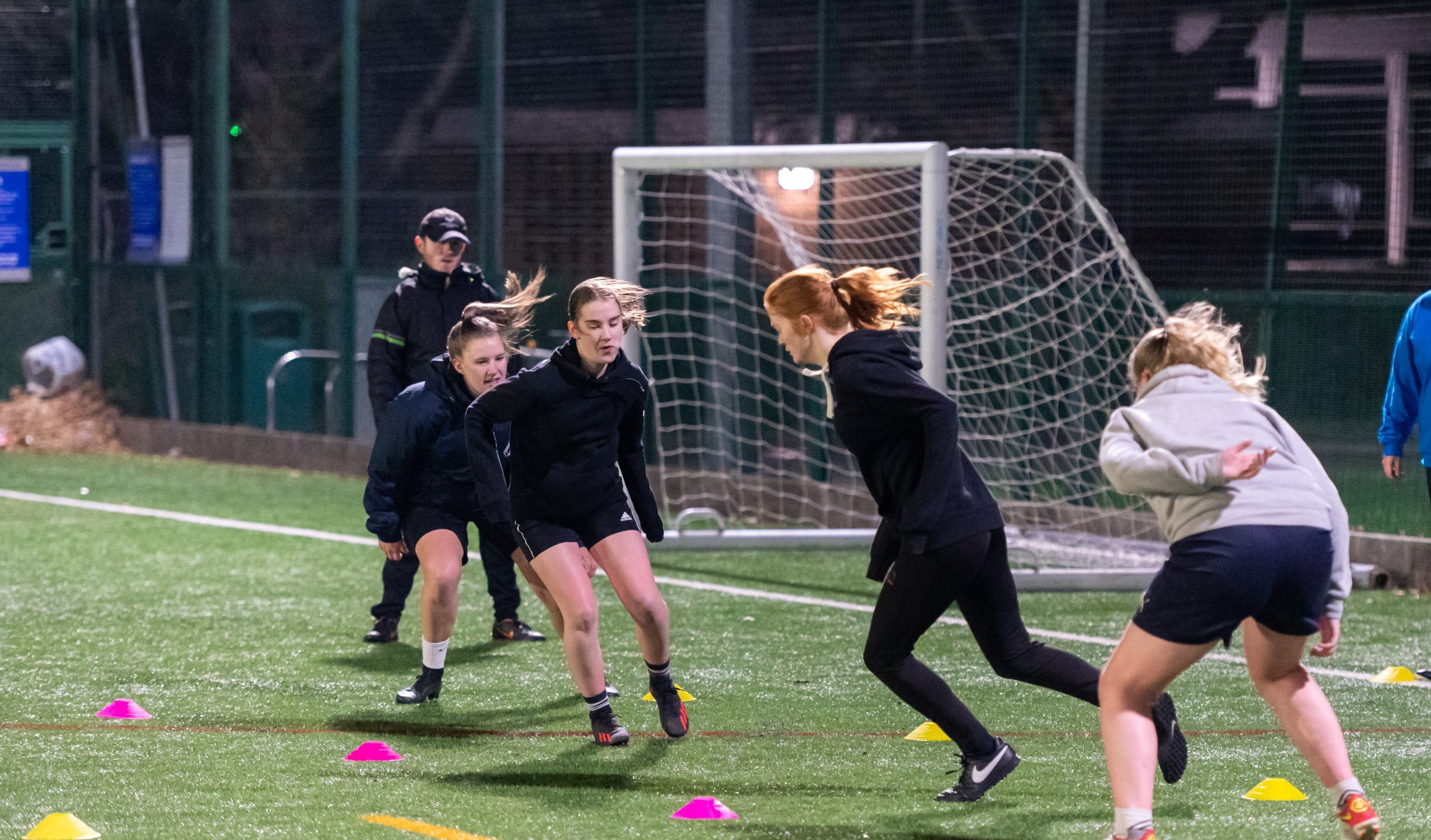 A group of women and girls playing football