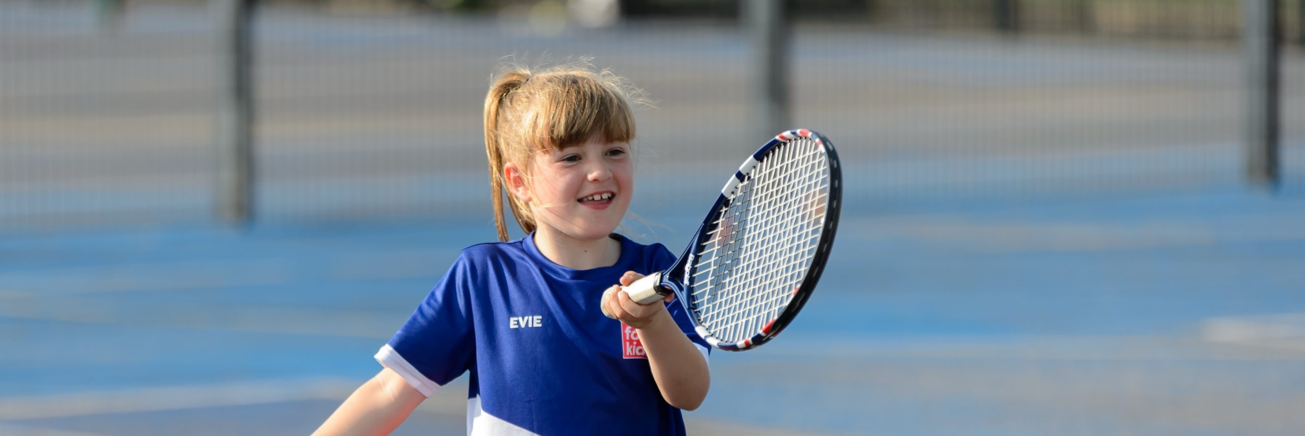 Young girl playing tennis