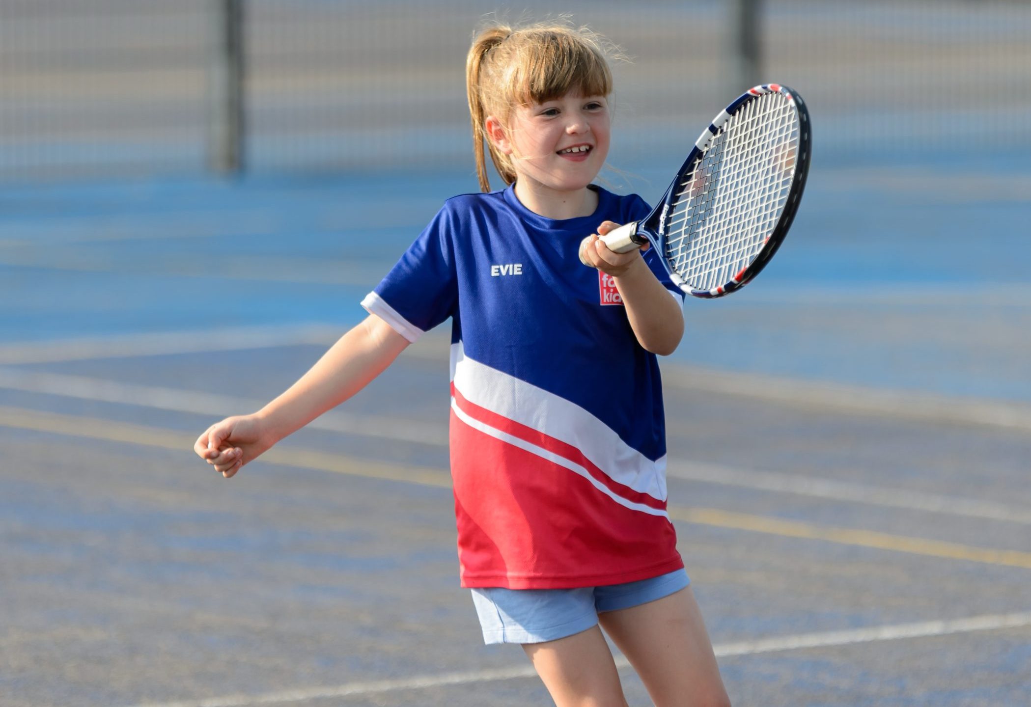 Little girl playing tennis