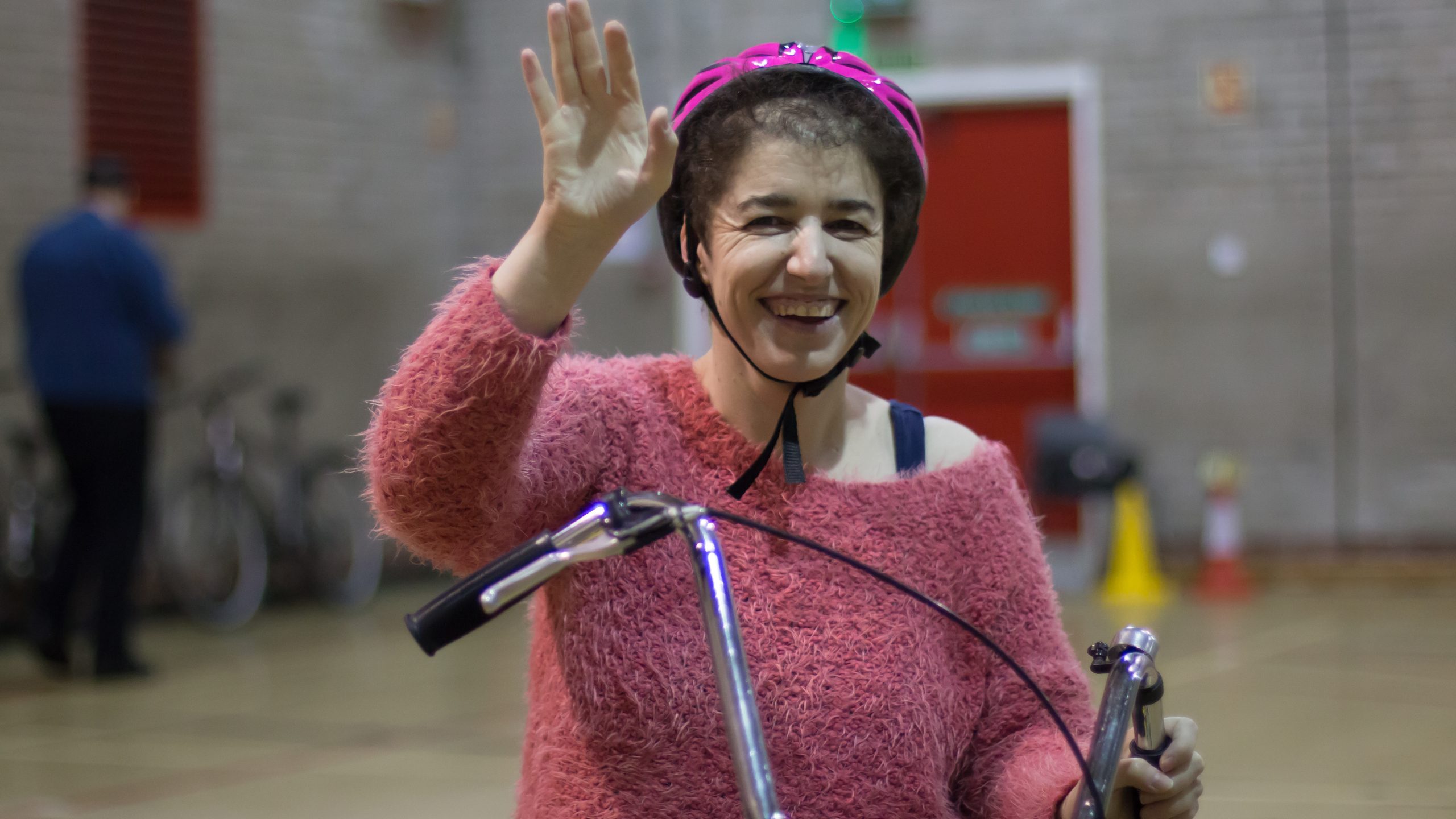 Woman aged 40-50 smiling riding a bike