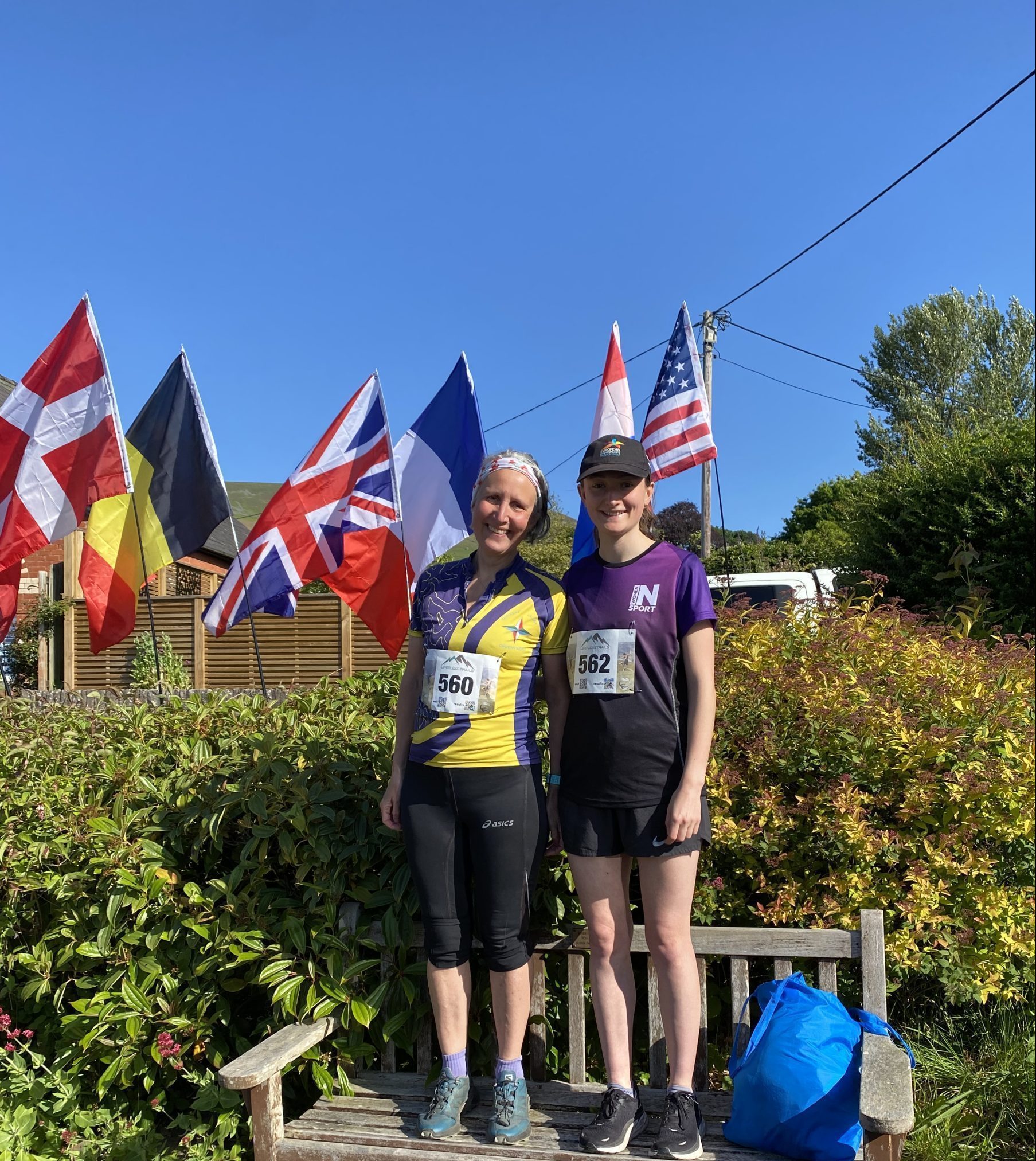 A mum and daughter smiling before a running race