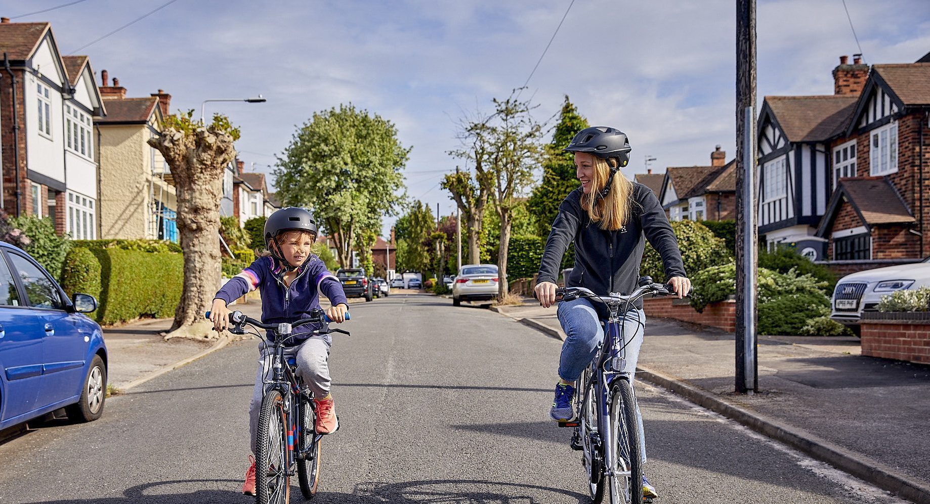 A mum and her young sun riding bikes together