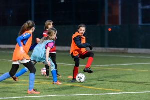 Young girls playing football