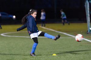 Young girl playing football