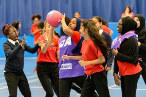 A group of high school girls playing basketball