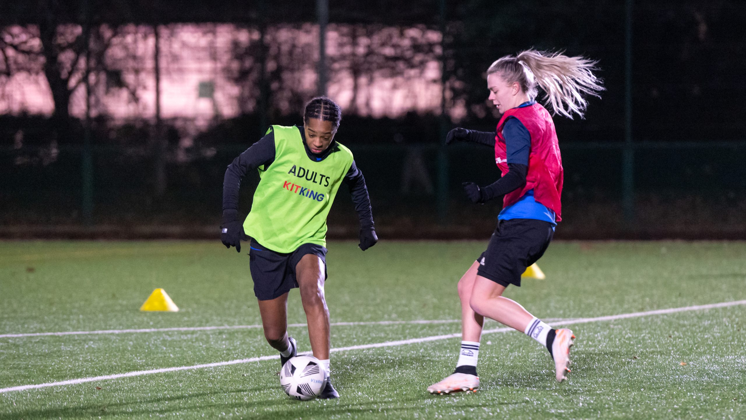 Two young women playing football