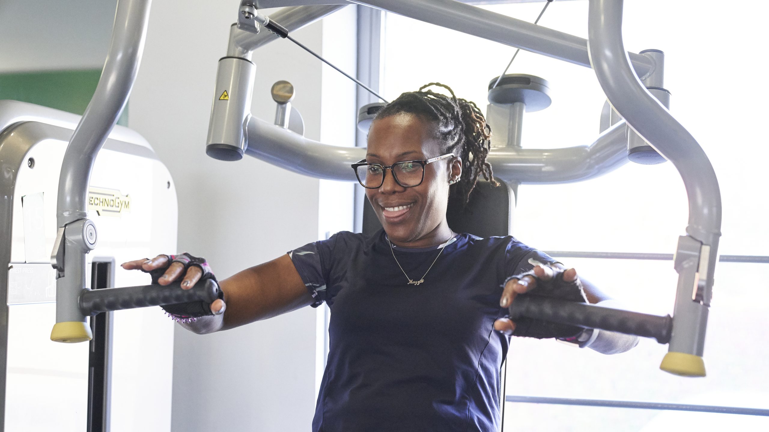 A black woman with braided hair at the gym