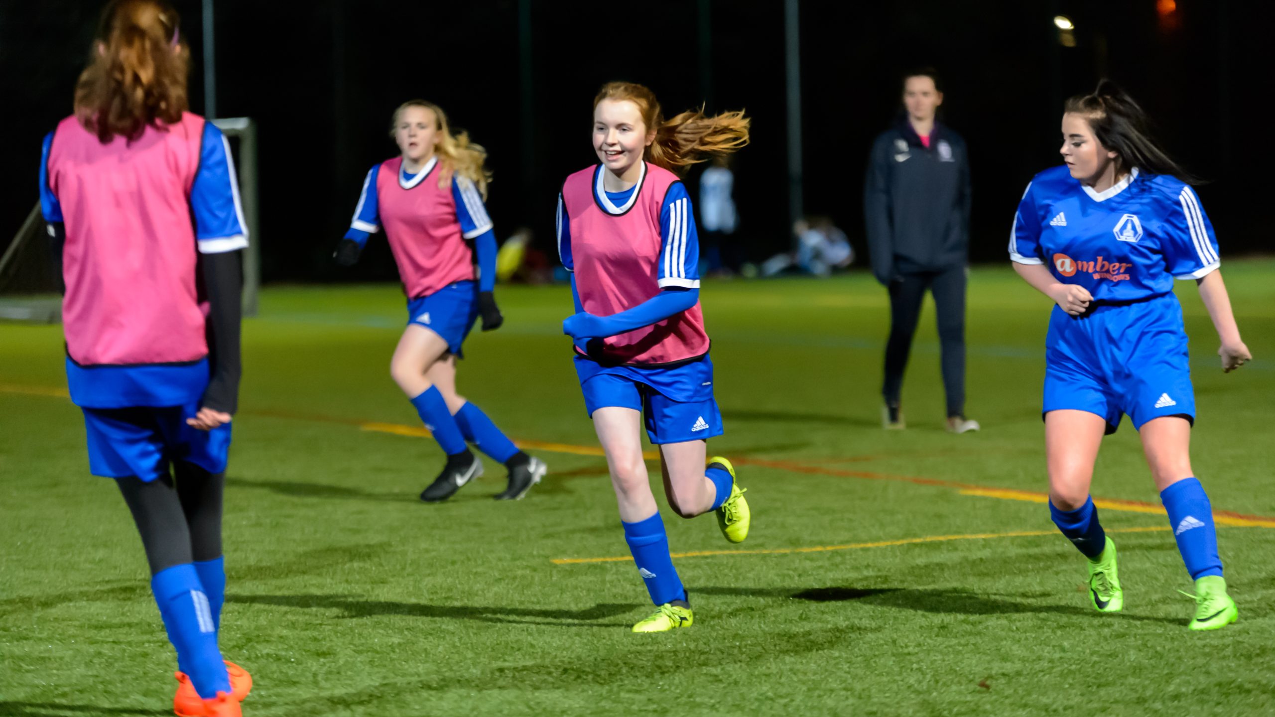 A group of young women aged 20-25 playing football