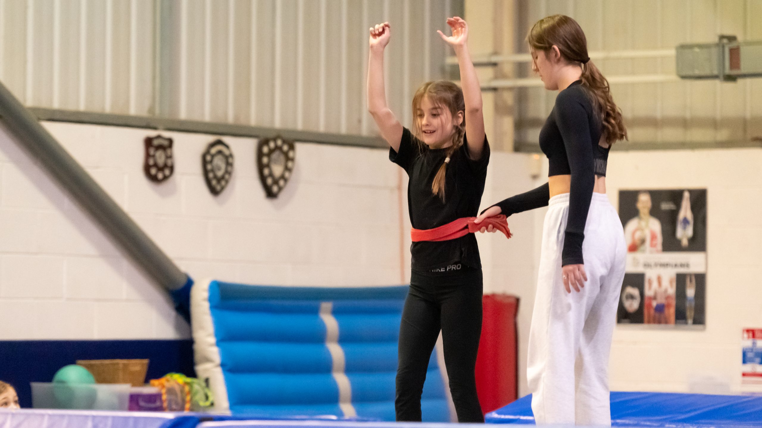 Two girls practicing gymnastics skills