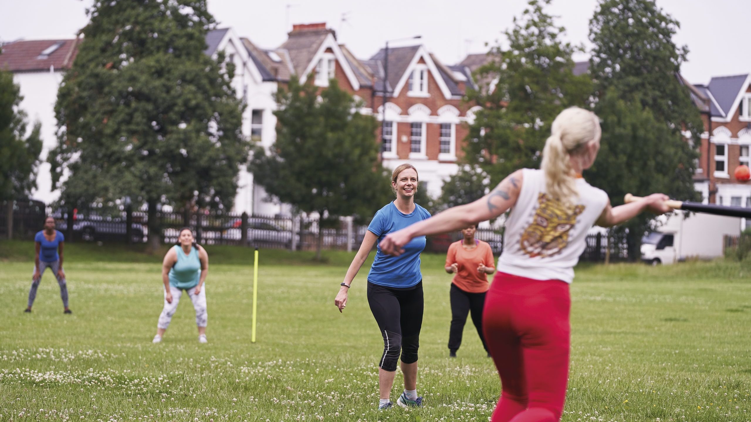 a group of women playing baseball