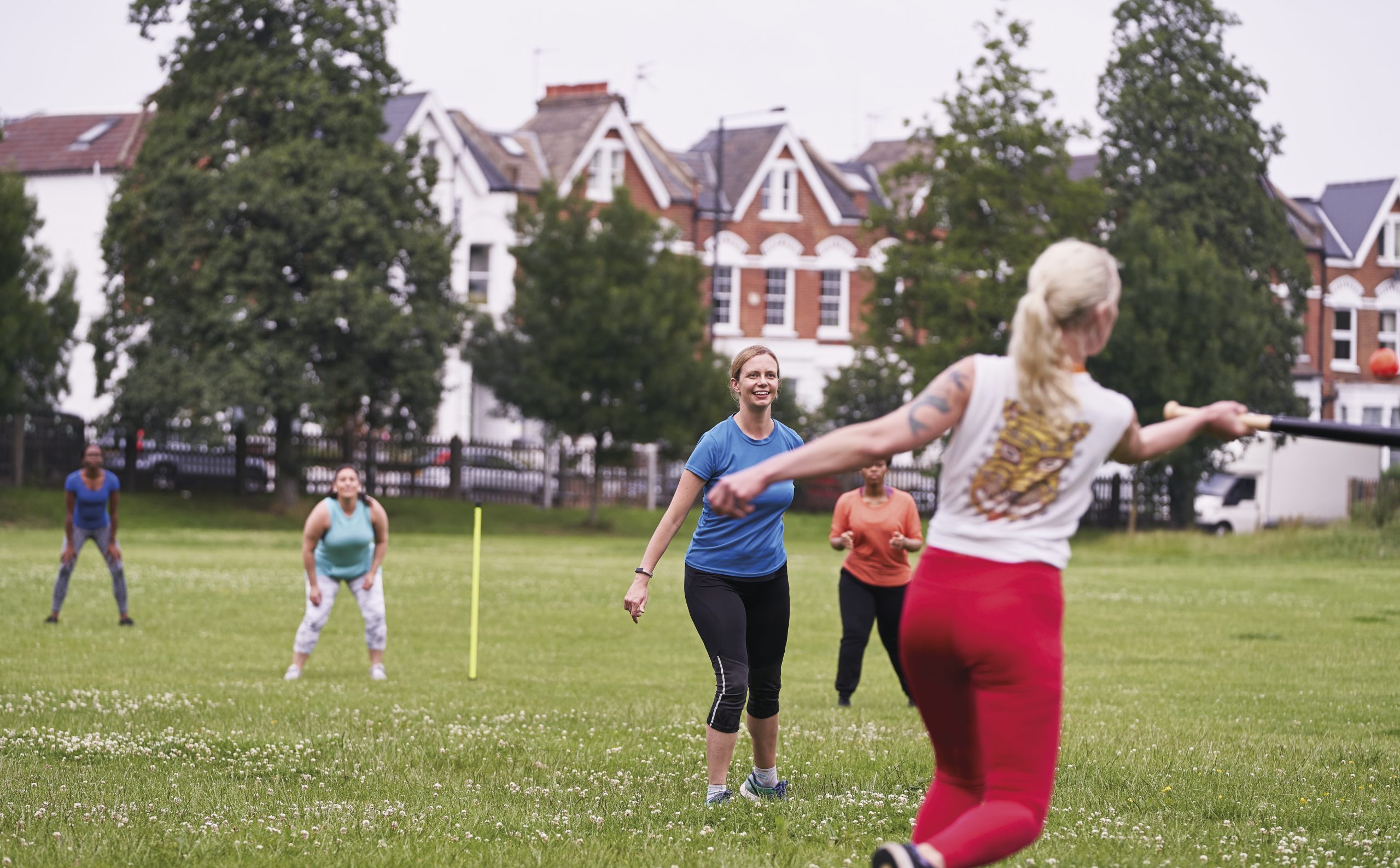 a group of women playing baseball