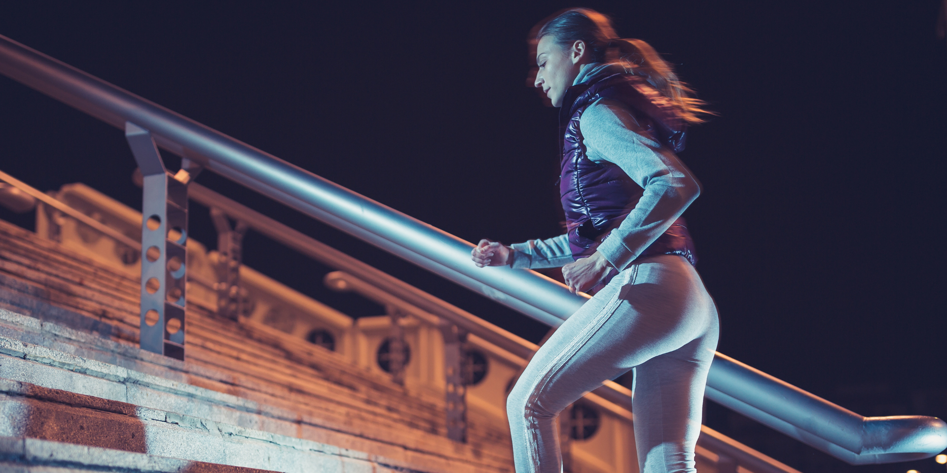 Woman running at night in her local public park