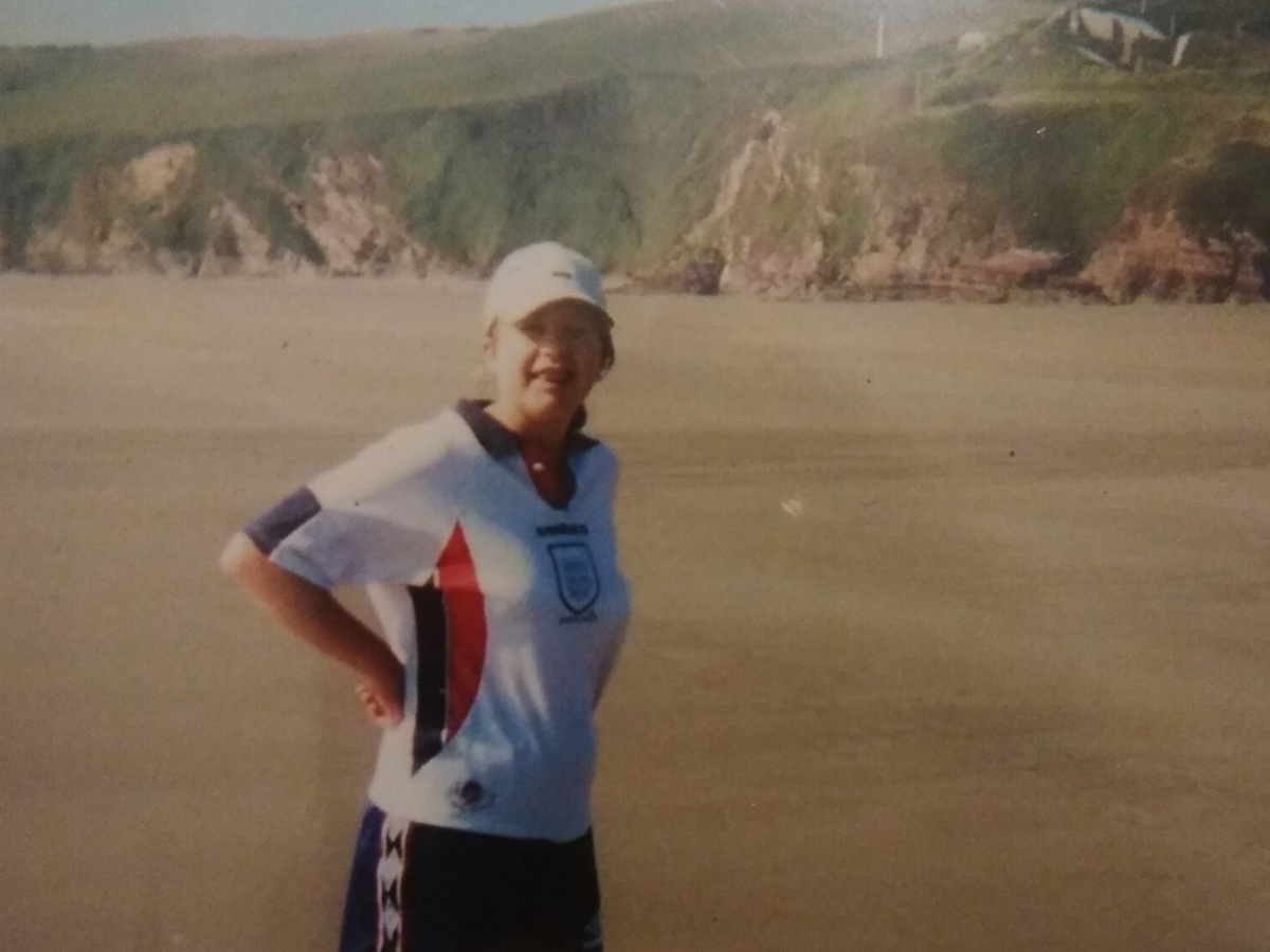 Gemma playing football on the beach