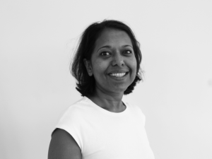 Harinie, a Sri Lankan woman with short brown hair, smiling